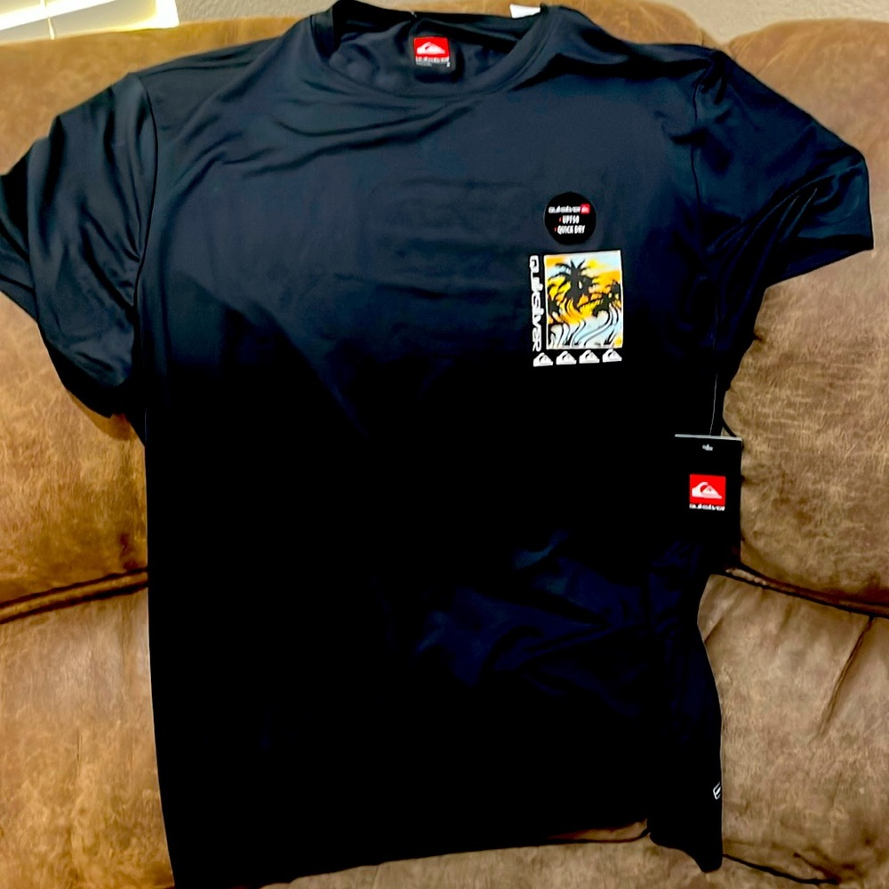 Men’s T shirt, brand is “quick silver” has designs on front and back.